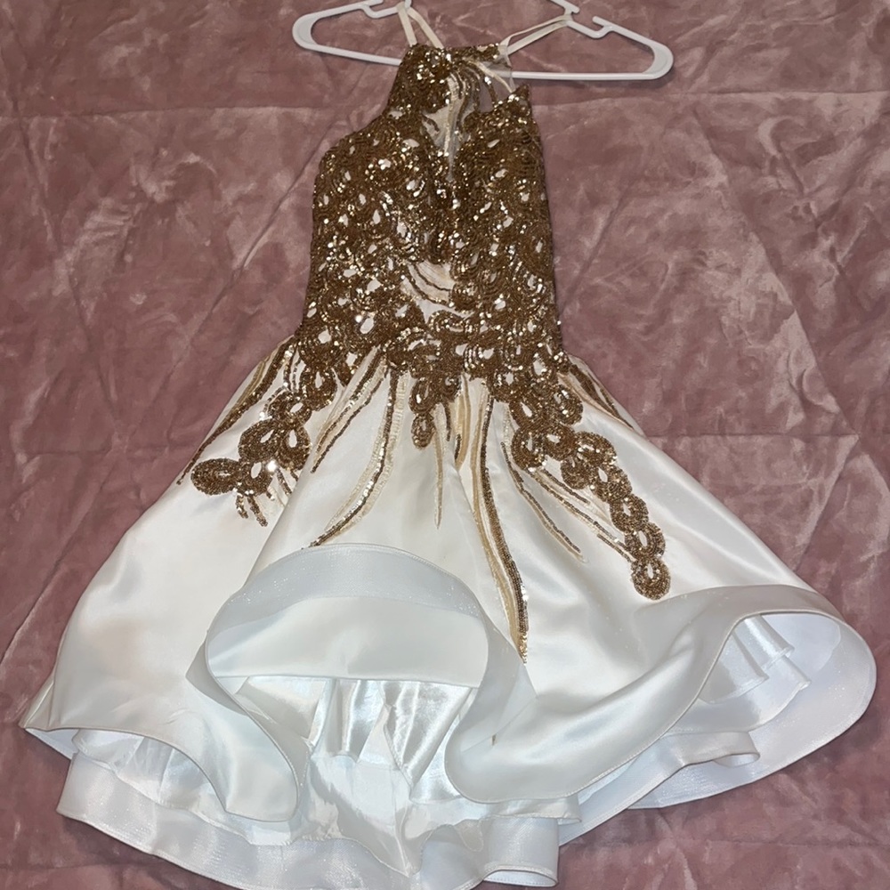 This dress was worn one time for homecoming very pretty gold and white dress!